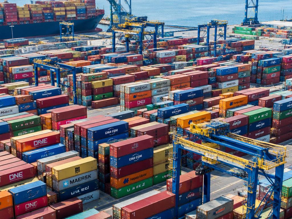 Aerial view of stacked shipping containers at a port terminal